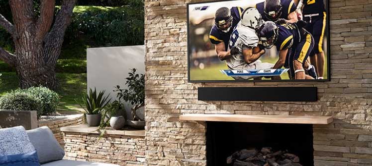 Outdoor TV mounted on brick wall